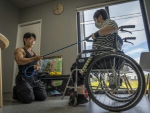 In Japan, bodybuilders are putting their muscles to work to help people cope with a staff shortage